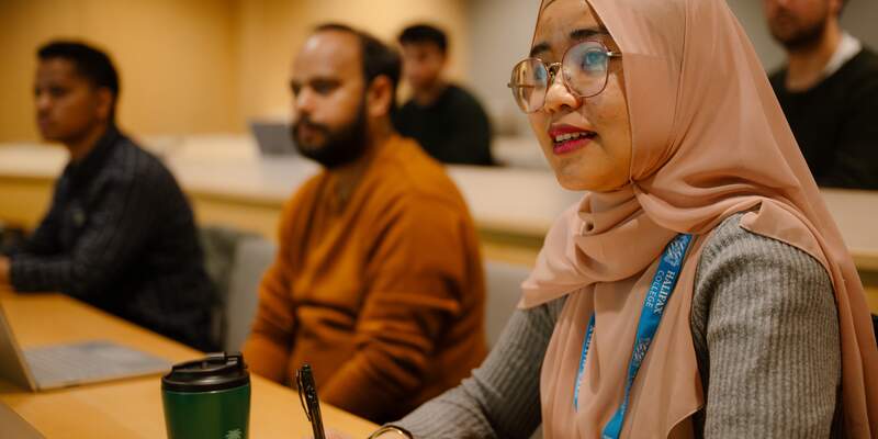 Students in the School for Business and Society in a lecture theatre.